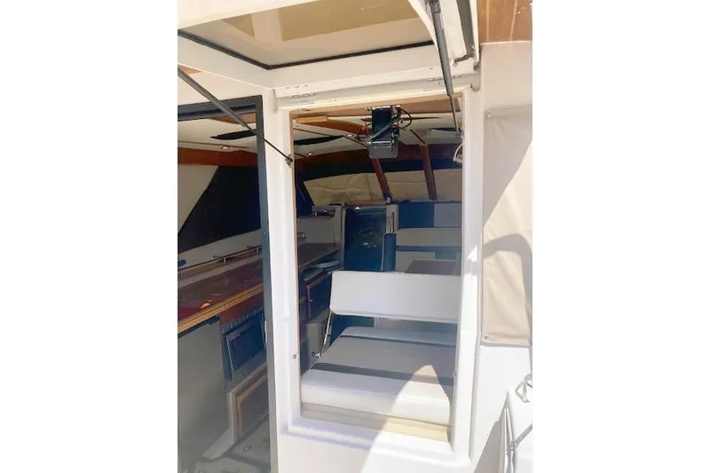 Slide: The Image of Interior view of a 2018 Cutwater C-30 Sedan boat, showcasing seating and cabin area. - 6