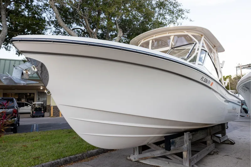 The Image of 2018 Grady-White Freedom 285 boat on display, parked on wooden supports. - 0