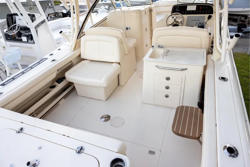Slide: The Image of 2018 Grady-White Freedom 285 boat interior with seating, sink, and storage compartments. - 4