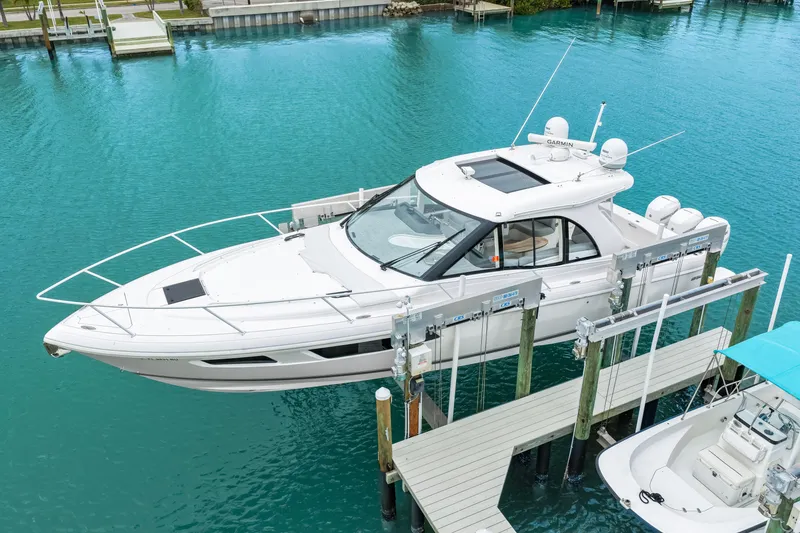 Slide: The Image of 2019 Intrepid 410 Evolution yacht docked in turquoise waters. - 10