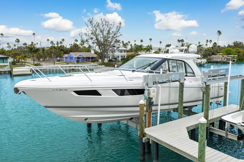 Slide: The Image of 2019 Intrepid 410 Evolution yacht docked on a lift in a scenic marina. - 11