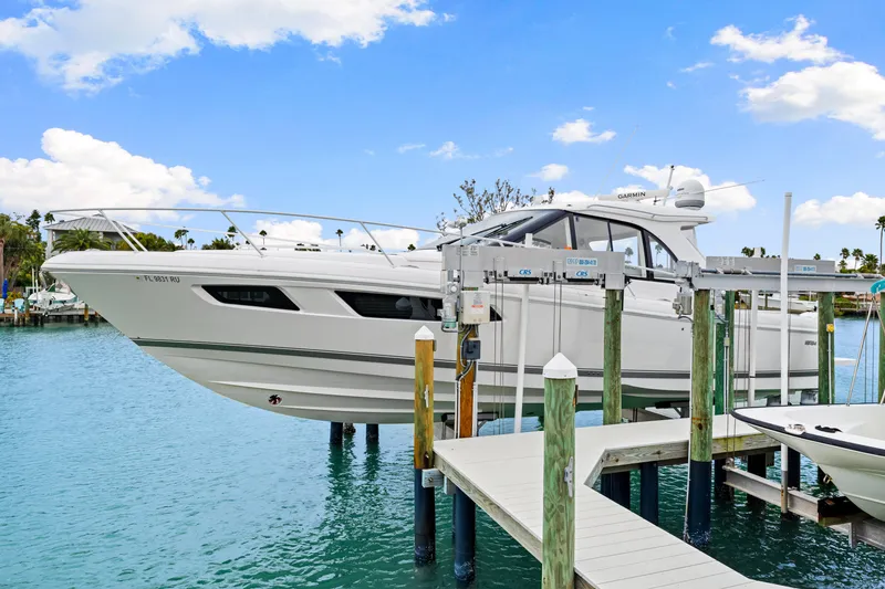 Slide: The Image of 2019 Intrepid 410 Evolution yacht docked on a lift in a marina. - 12