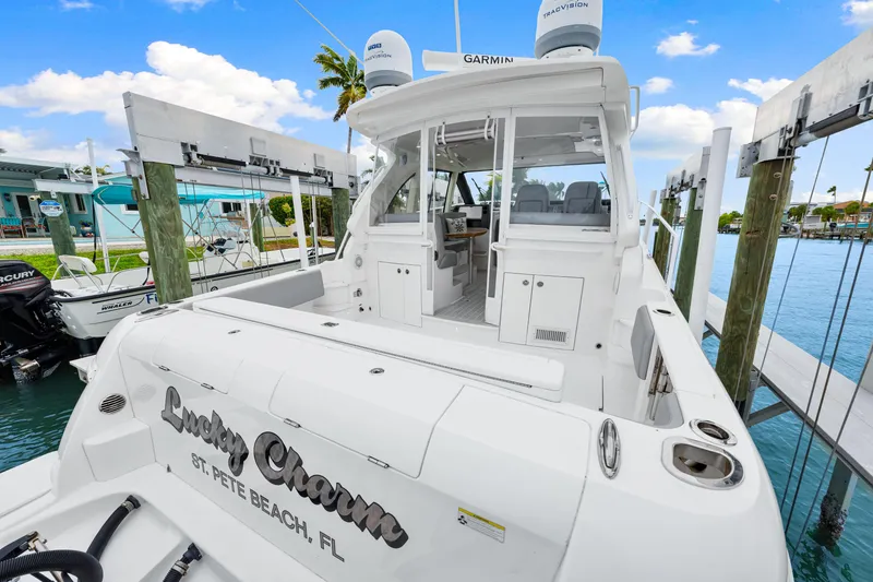 Slide: The Image of 2019 Intrepid 410 Evolution boat docked, featuring spacious deck and modern design. - 17