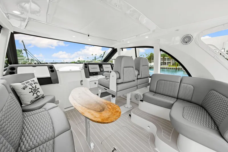Slide: The Image of Luxurious interior of 2019 Intrepid 410 Evolution yacht with modern seating and navigation equipment. - 41