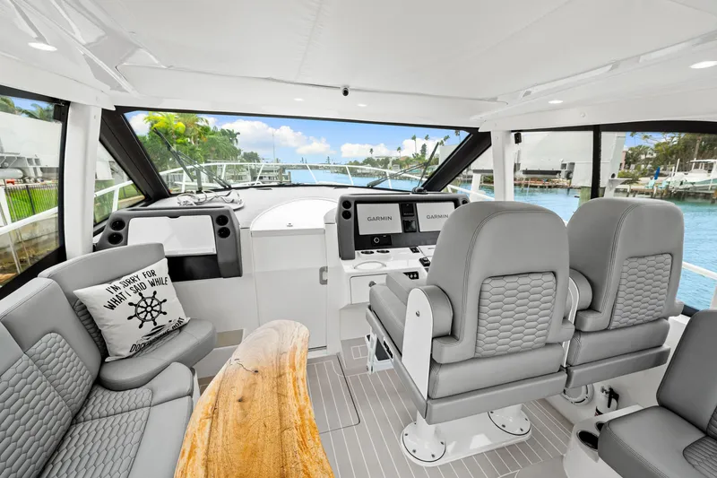 Slide: The Image of Interior of 2019 Intrepid 410 Evolution yacht with modern seating and navigation equipment. - 42