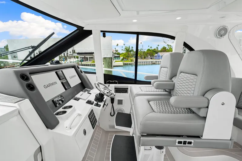 Slide: The Image of 2019 Intrepid 410 Evolution helm with dual Garmin displays and luxurious seating. - 43