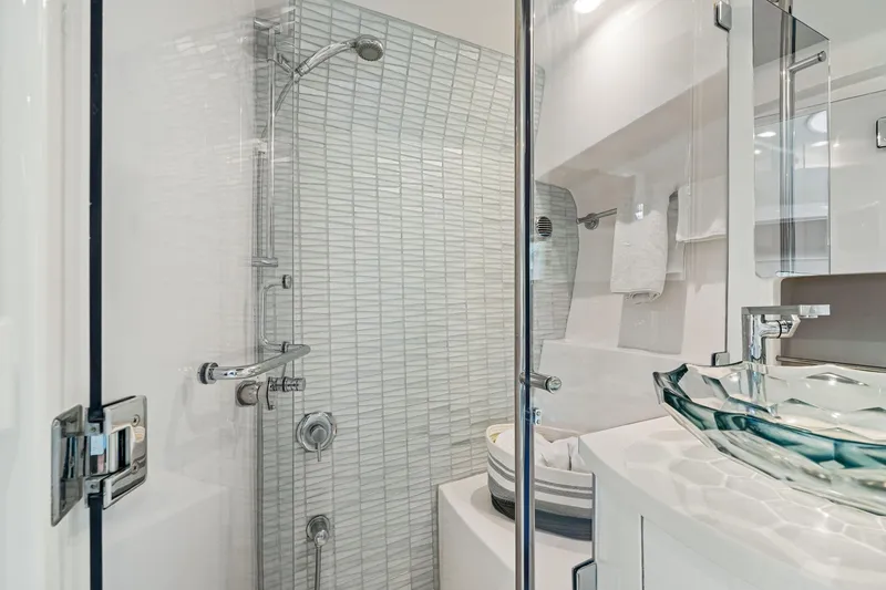 Slide: The Image of Luxurious bathroom in 2019 Intrepid 410 Evolution yacht with modern glass sink and shower. - 63