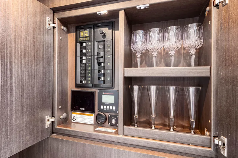 Slide: The Image of Electrical panel and glassware cabinet in 2019 Intrepid 410 Evolution yacht interior. - 64
