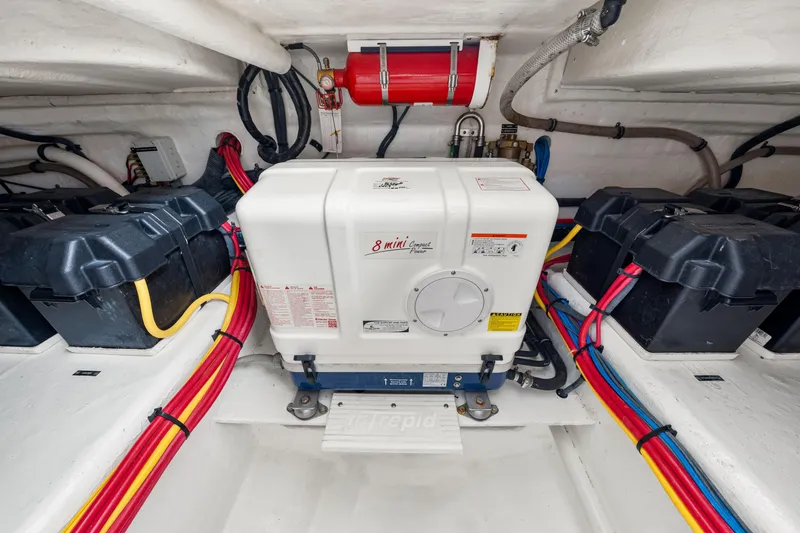 Slide: The Image of Engine room of 2019 Intrepid 410 Evolution with generator and battery setup. - 65