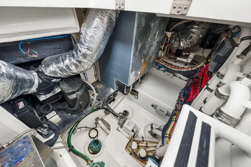 Slide: The Image of Engine room of 2019 Intrepid 410 Evolution boat with complex wiring and machinery. - 66