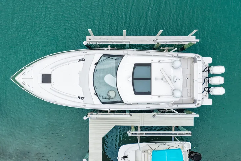 Slide: The Image of Aerial view of 2019 Intrepid 410 Evolution yacht docked in turquoise water. - 9