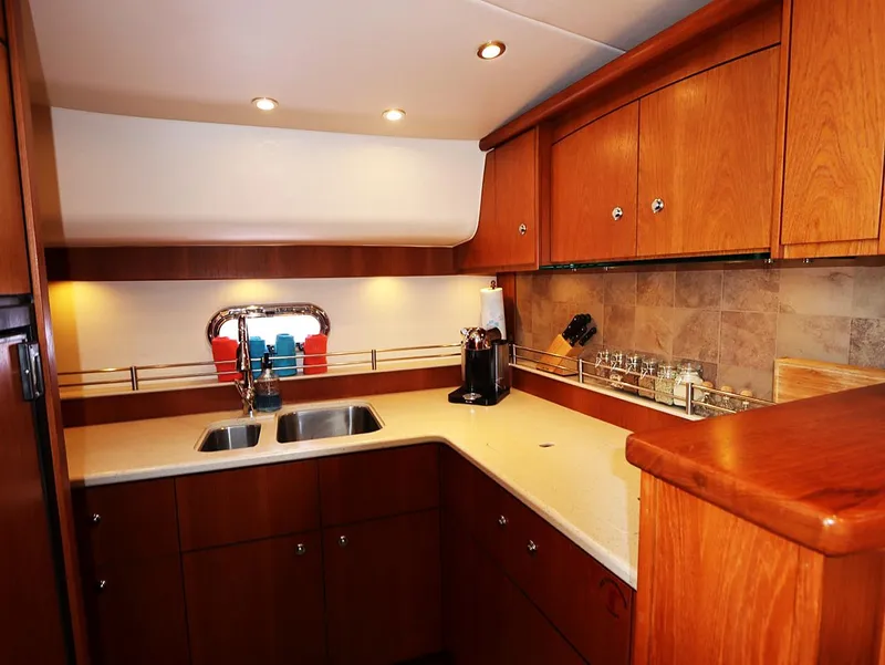 Slide: The Image of Luxurious 2009 Tiara Yachts 4300 Sovran kitchen with wooden cabinets and modern amenities. - 11