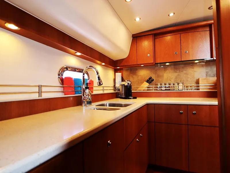 Slide: The Image of Luxurious kitchen interior of 2009 Tiara Yachts 4300 Sovran with wood cabinetry and modern fixtures. - 12