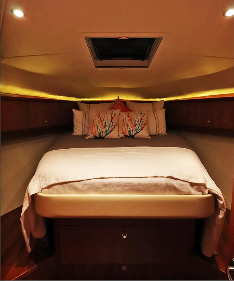 Slide: The Image of 2009 Tiara Yachts 4300 Sovran cabin with cozy bed and ambient lighting. - 13