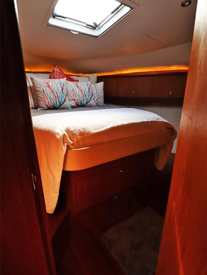 Slide: The Image of Luxurious cabin interior of 2009 Tiara Yachts 4300 Sovran with cozy bedding and ambient lighting. - 14