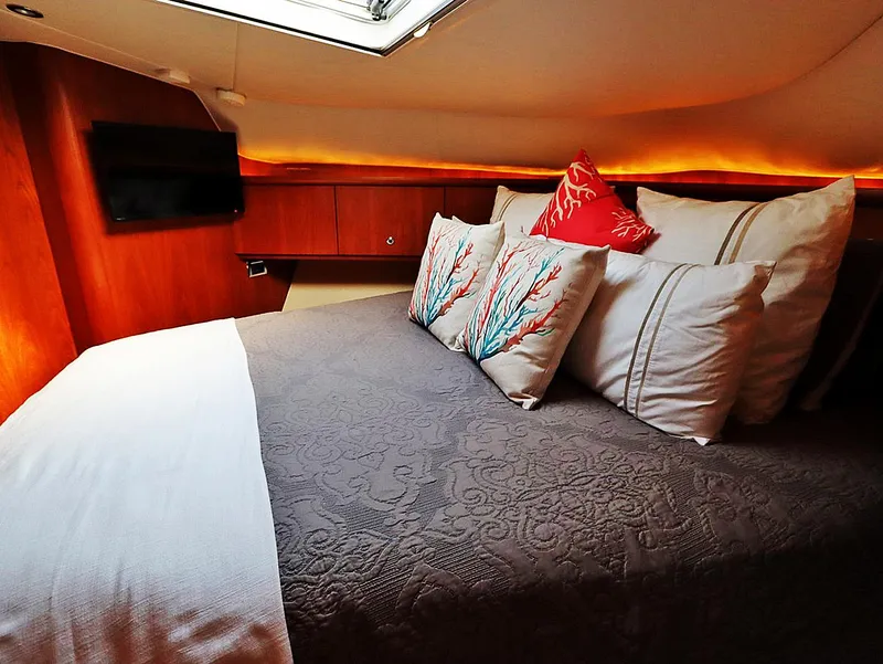 Slide: The Image of Luxurious cabin interior of 2009 Tiara Yachts 4300 Sovran with elegant bedding and ambient lighting. - 15
