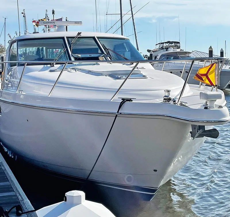 Slide: The Image of 2009 Tiara Yachts 4300 Sovran docked at marina, showcasing sleek design and luxury features. - 17