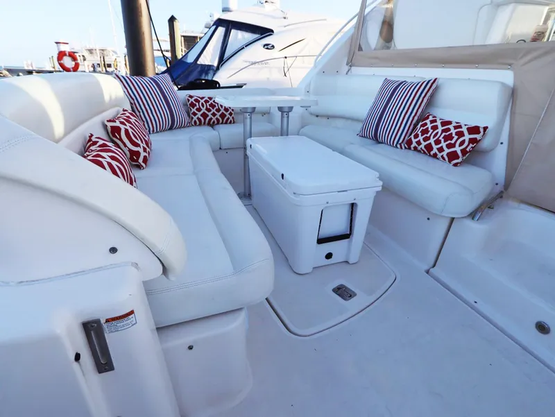 Slide: The Image of 2009 Tiara Yachts 4300 Sovran interior with white seating and colorful cushions. - 21