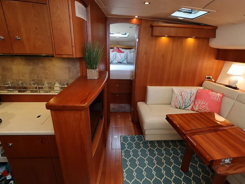 Slide: The Image of Luxurious interior of 2009 Tiara Yachts 4300 Sovran with wood finish and cozy seating area. - 9