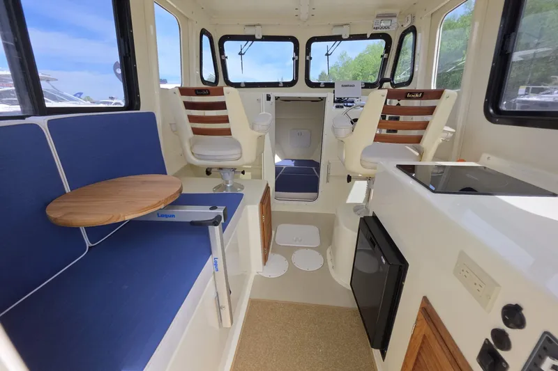 Slide: The Image of Interior of 2018 Rosborough 22 Cape Breton boat with seating and navigation area. - 13