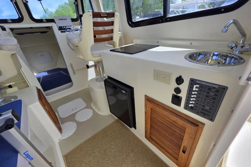 Slide: The Image of Interior of 2018 Rosborough 22 Cape Breton boat with kitchenette and seating area. - 15