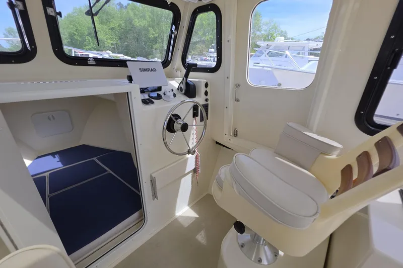Slide: The Image of 2018 Rosborough 22 Cape Breton boat interior with steering wheel and seating. - 16