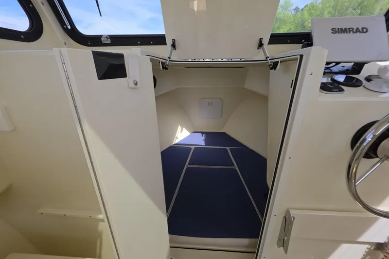 Slide: The Image of 2018 Rosborough 22 Cape Breton cabin interior with steering wheel and navigation equipment. - 20