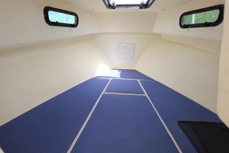 Slide: The Image of Interior cabin of 2018 Rosborough 22 Cape Breton boat with blue cushions and windows. - 21