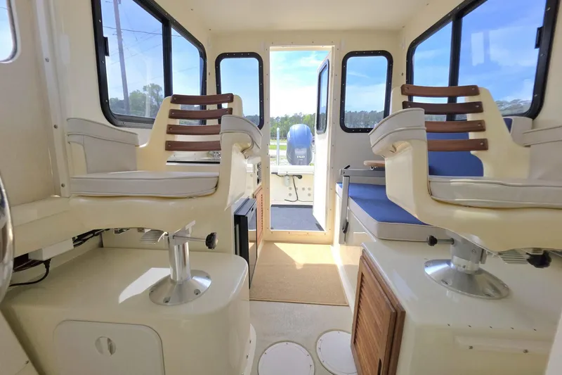 Slide: The Image of Interior of 2018 Rosborough 22 Cape Breton boat with seating and windows. - 22