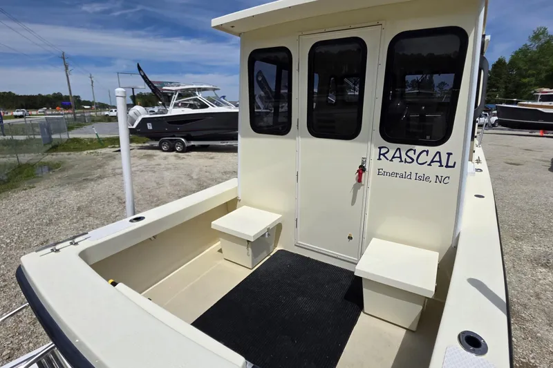 Slide: The Image of 2018 Rosborough 22 Cape Breton boat, rear view, docked with seating and cabin entry. - 5