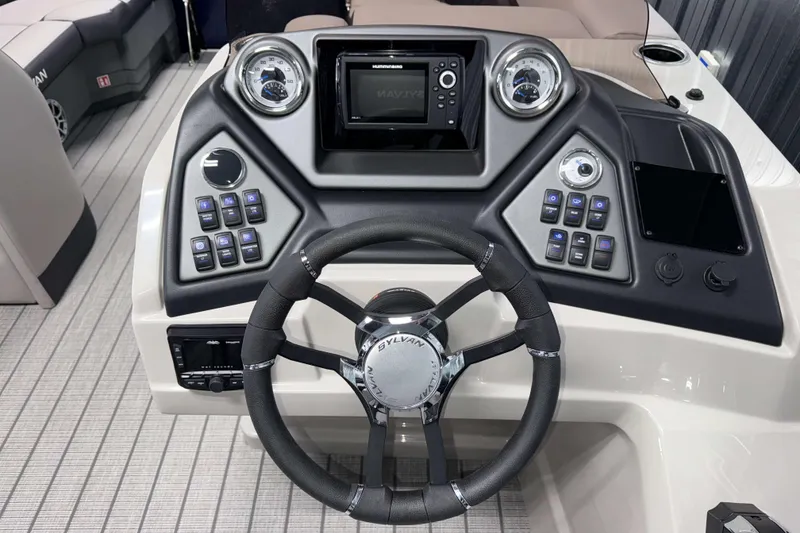 Slide: The Image of 2026 Sylvan L1 LZ boat dashboard with steering wheel and control panel. - 11