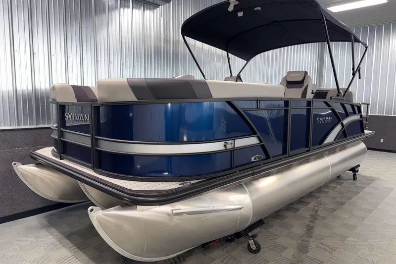 Slide: The Image of 2026 Sylvan L1 LZ pontoon boat with blue exterior in a showroom. - 20