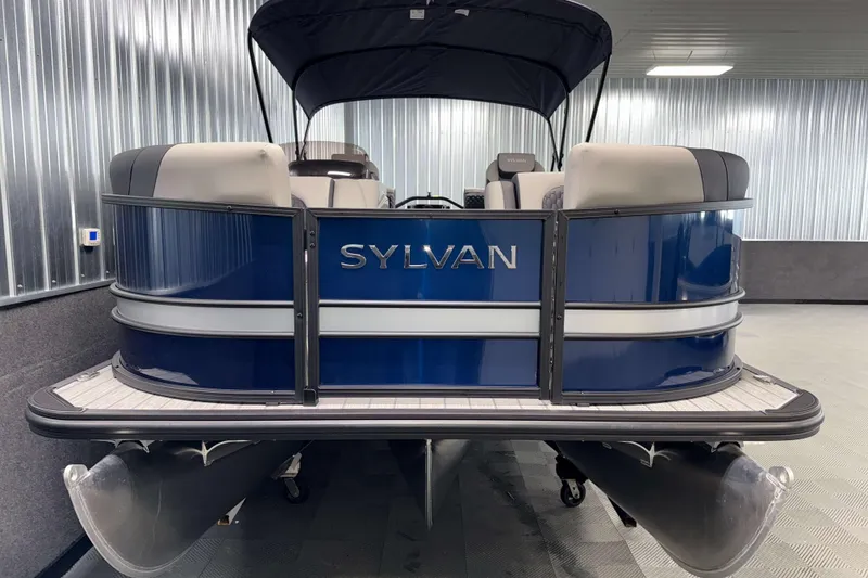 Slide: The Image of 2026 Sylvan L1 LZ pontoon boat in a showroom, featuring sleek blue design. - 21