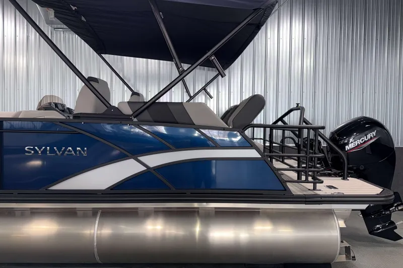 Slide: The Image of 2026 Sylvan L1 LZ pontoon boat with Mercury engine, blue and white design. - 25