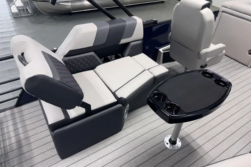 Slide: The Image of 2026 Sylvan L1 LZ boat interior with gray seating and black table. - 6
