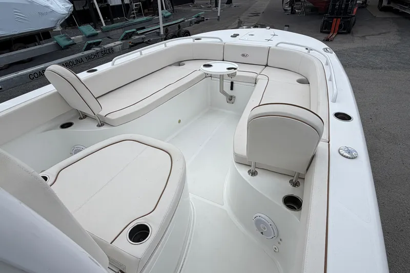 Slide: The Image of 2021 Sea Hunt Escape 27 boat interior with white seating and table. - 5