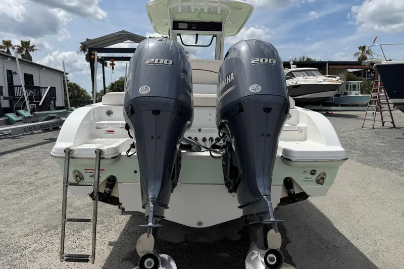 Slide: The Image of 2021 Sea Hunt Escape 27 with twin Yamaha 200 engines, docked outdoors. - 8