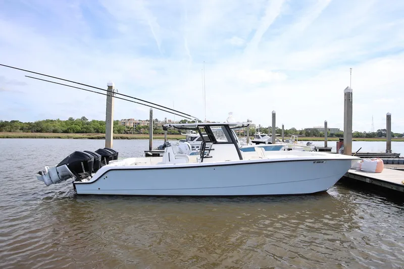 The Image of 2020 Invincible 35 Catamaran docked at marina, featuring dual outboard engines. - 1