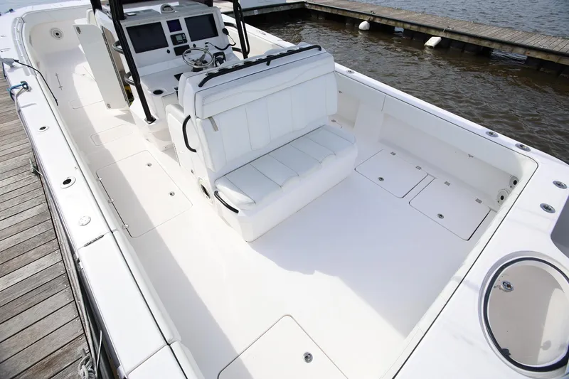 Slide: The Image of 2020 Invincible 35 Catamaran boat interior with white seating and control panel. - 11