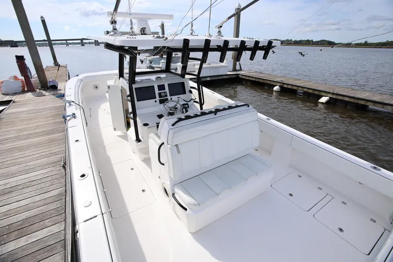 Slide: The Image of 2020 Invincible 35 Catamaran docked, showcasing spacious deck and modern helm controls. - 12
