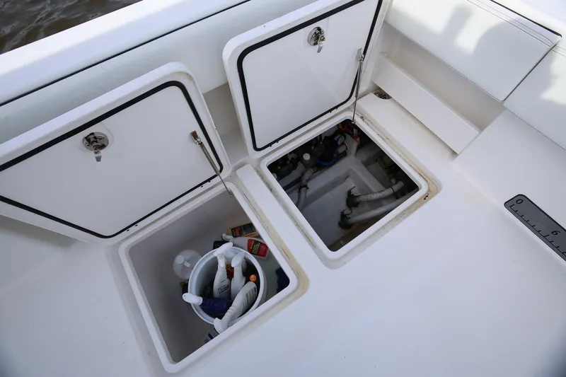 Slide: The Image of Storage compartments on a 2020 Invincible 35 Catamaran, featuring cleaning supplies and equipment. - 14