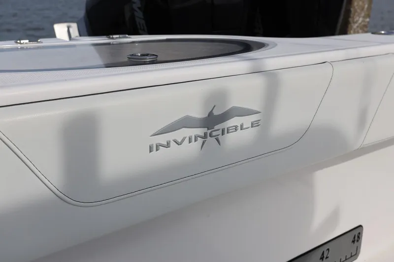 Slide: The Image of Invincible 35 Catamaran 2020 logo detail on sleek white surface. - 15