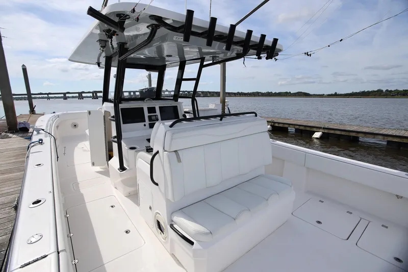 Slide: The Image of 2020 Invincible 35 Catamaran docked, showcasing spacious seating and modern helm. - 17