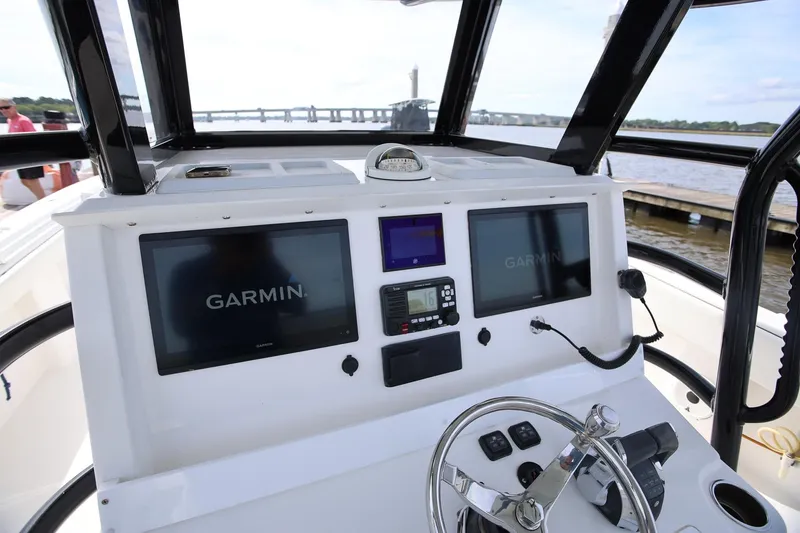 Slide: The Image of Control panel of 2020 Invincible 35 Catamaran with Garmin displays and steering wheel. - 19