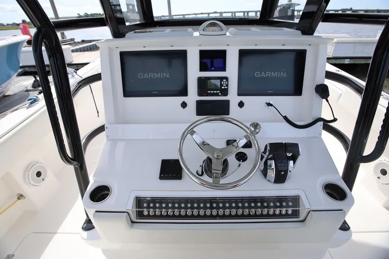 Slide: The Image of Center console of 2020 Invincible 35 Catamaran with Garmin navigation displays and controls. - 20