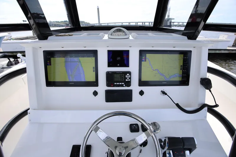 Slide: The Image of Cockpit of 2020 Invincible 35 Catamaran with dual navigation screens and steering wheel. - 21