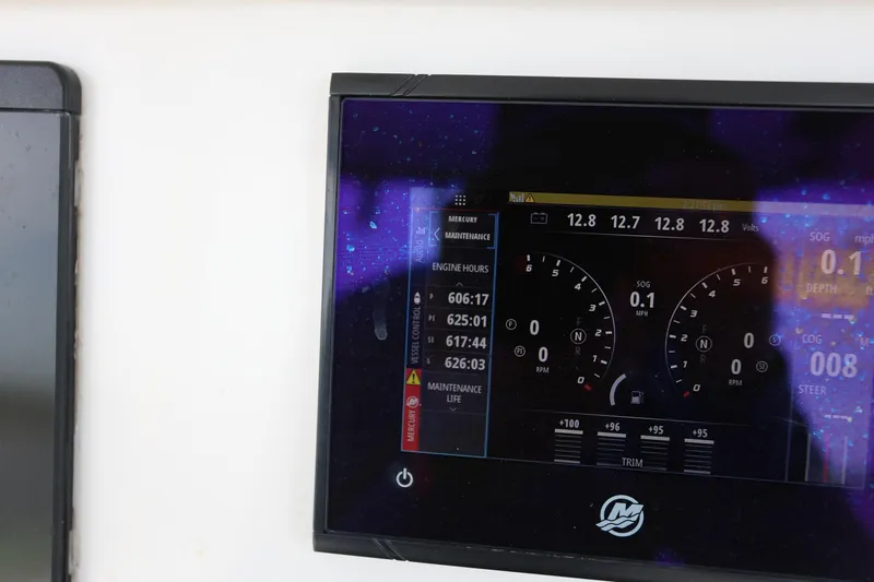 Slide: The Image of Dashboard display of a 2020 Invincible 35 Catamaran showing engine hours and performance metrics. - 22