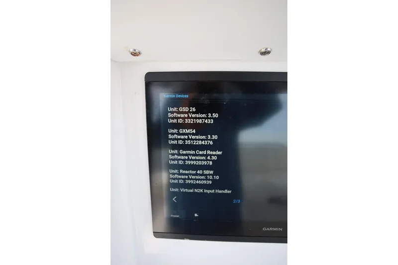 Slide: The Image of Garmin device display on 2020 Invincible 35 Catamaran showing software versions and unit IDs. - 24