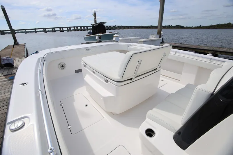 Slide: The Image of 2020 Invincible 35 Catamaran with spacious seating, docked by a scenic waterfront. - 26