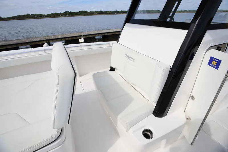 Slide: The Image of 2020 Invincible 35 Catamaran interior with white seating, dockside view. - 28